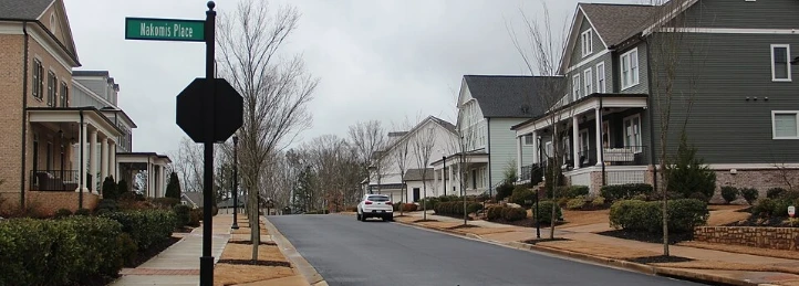 Residential street with Morris Place sign, sidewalks, parked car, and craftsman-style homes.
